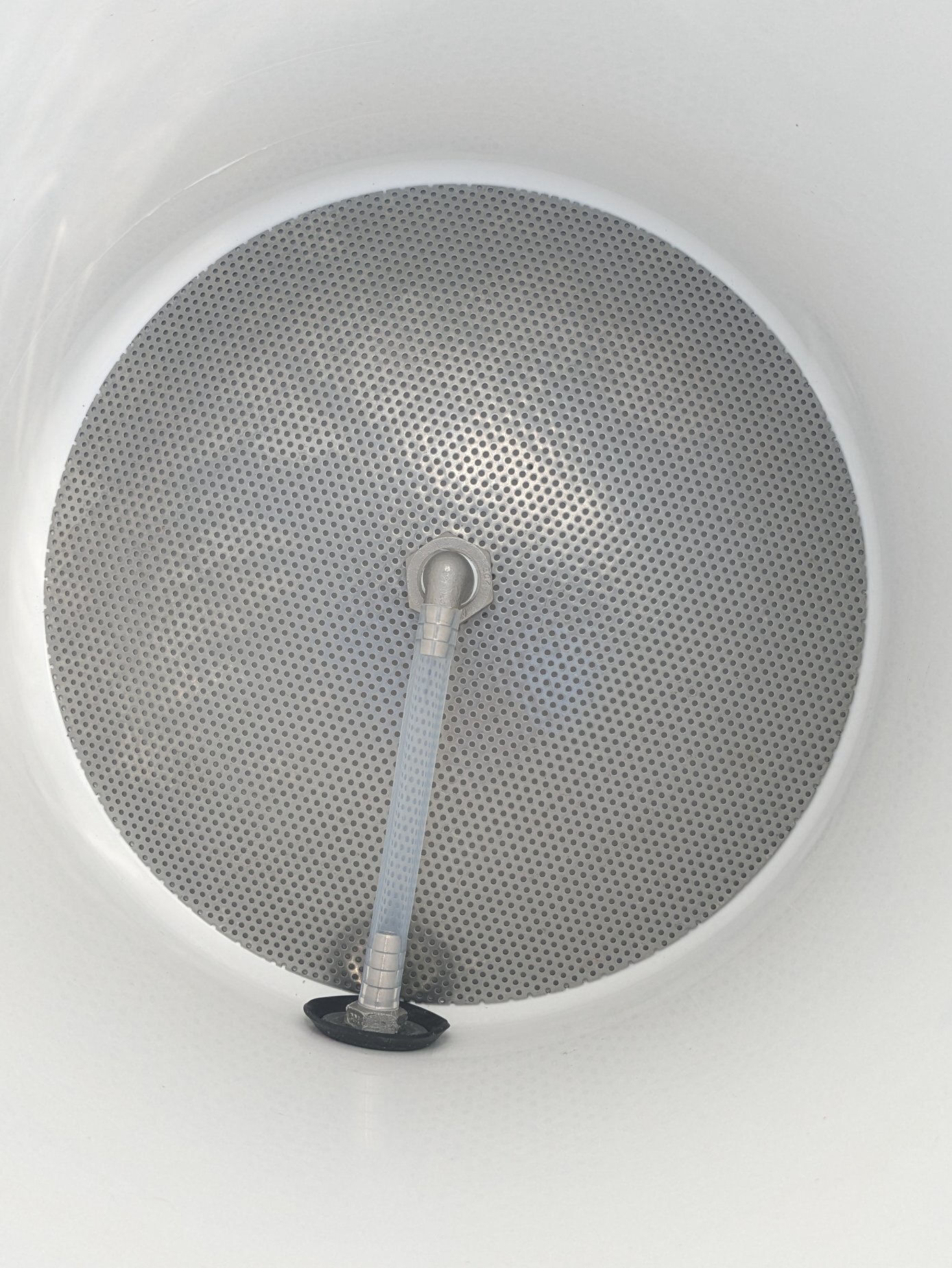 Stainless steel false bottom inside of a 10 gallon igloo water cooler.